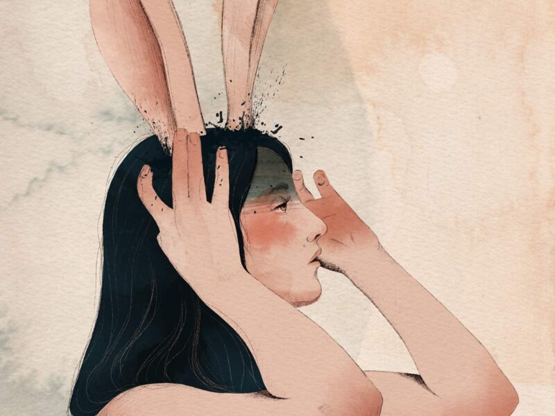 nude girl that has head in hands and has long rabbit ears